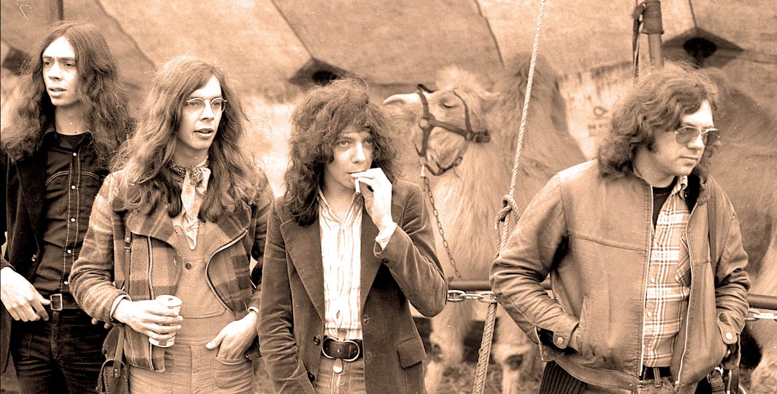 Vintage black-and-white photograph of The Beatles members John Lennon, George Harrison, Paul McCartney, and Ringo Starr during a film shoot, showcasing iconic 1960s music and cultural history for Sound Archive news and music enthusiasts.