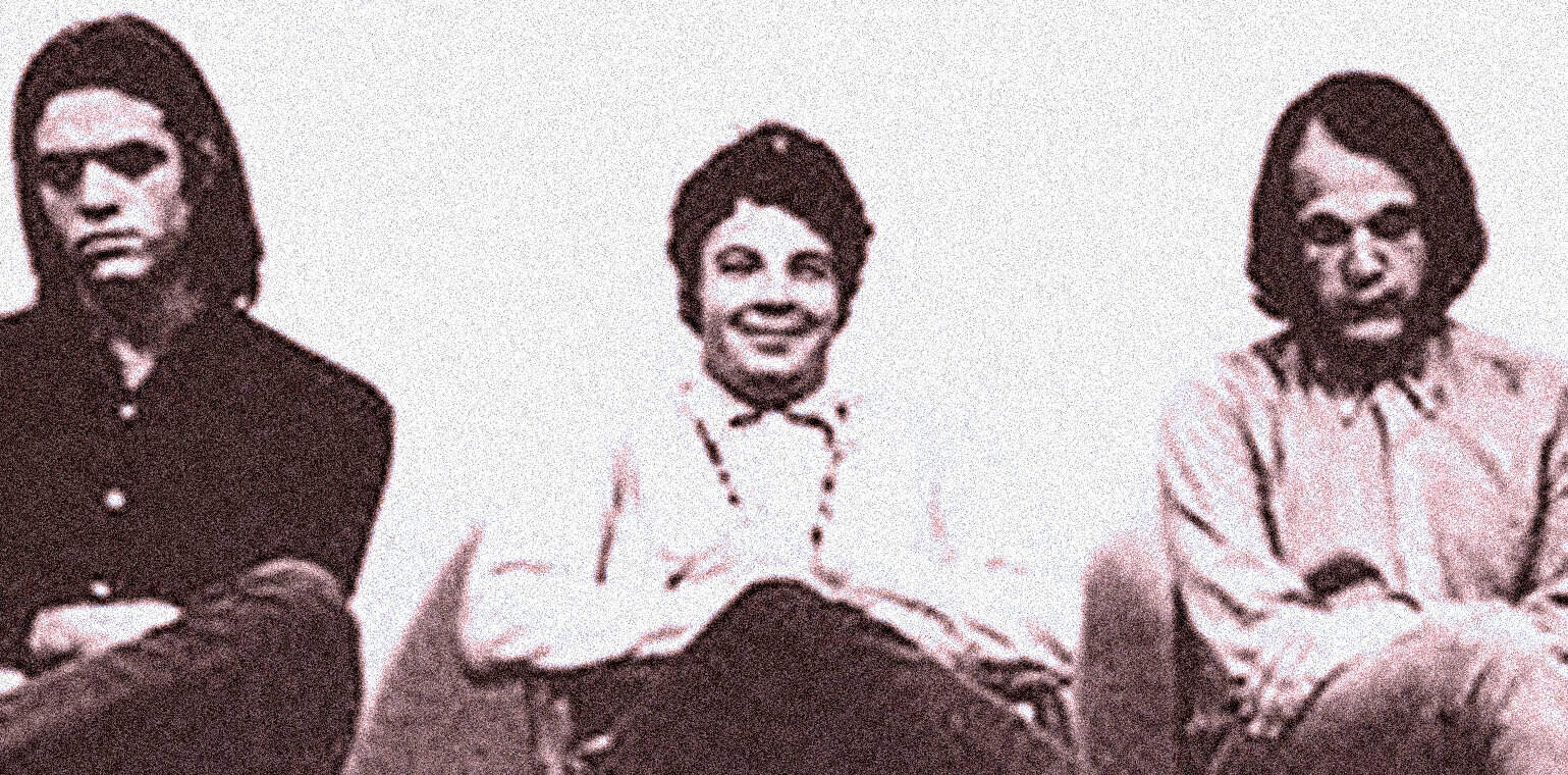 Black and white photo of The Supremes, a legendary Motown girl group, sitting with arms crossed and smiling, representing music history and iconic 1960s musical entertainment.