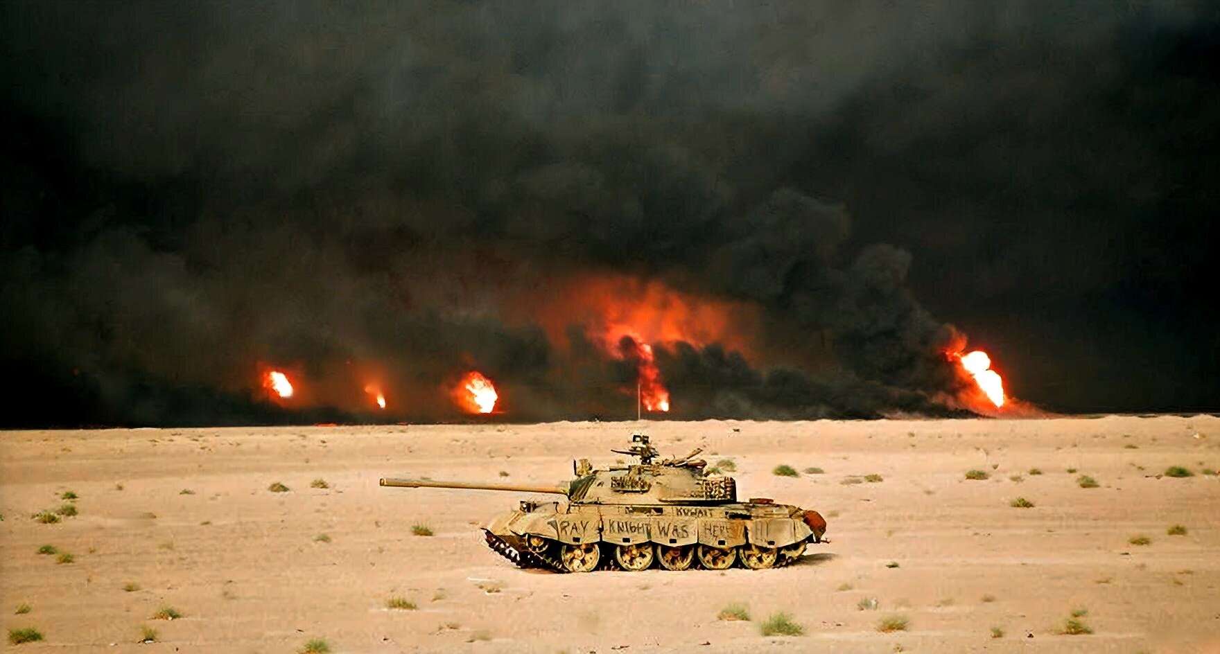 Tank in a desert with multiple explosions and smoke in the background, representing war, military conflict, or warfare scenes. Perfect for illustrating historical military events or war coverage related to news, history, and music archives.