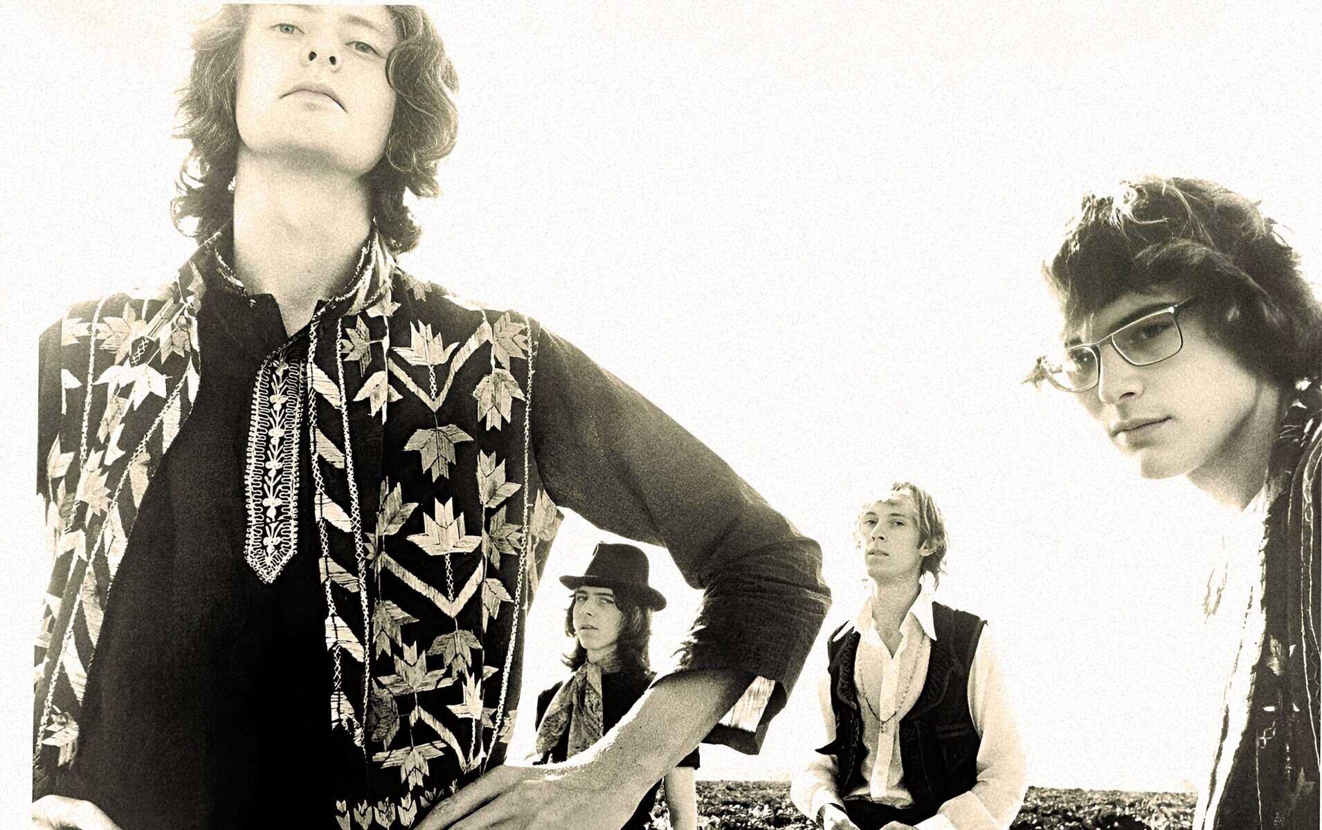 Vintage indie rock band photo from the 1960s with band members wearing retro clothing, emphasizing music history and classic rock era.
