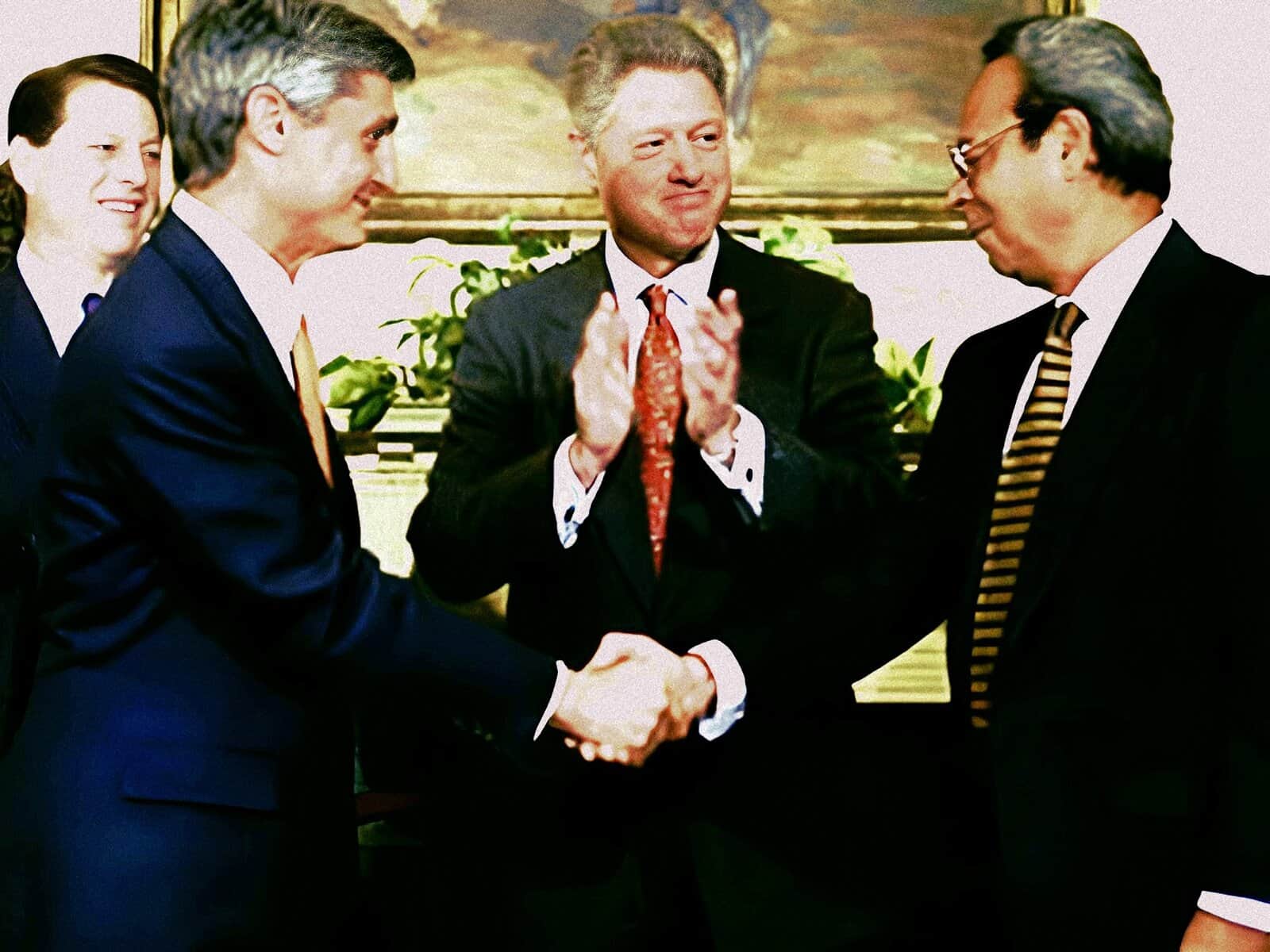 Handshake between business professionals at a formal meeting, representing news, history, and music archives from Past Daily.