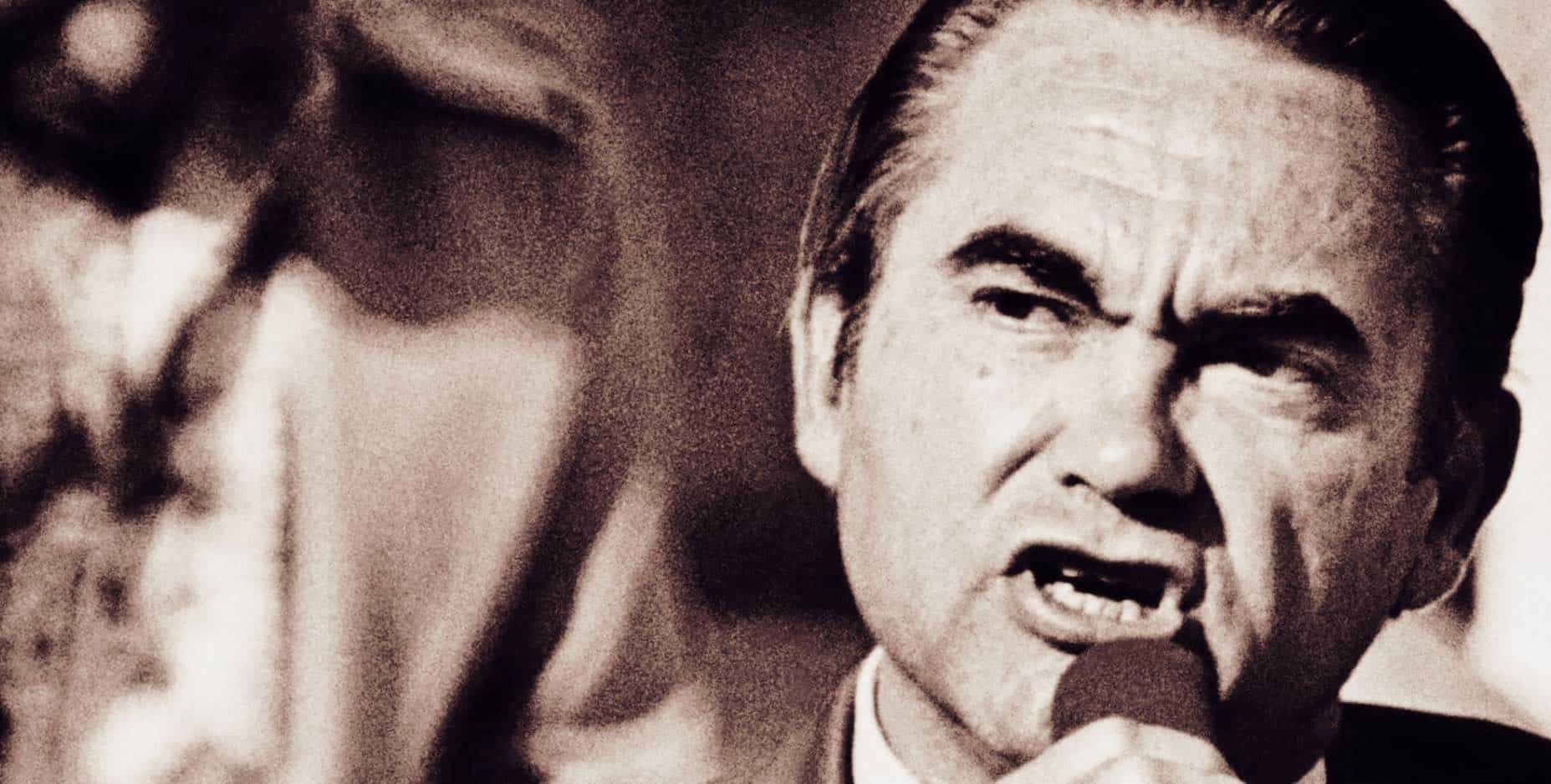 Vintage black and white photo of a charismatic male singer performing with passion, capturing a moment of musical history and powerful vocal expression.