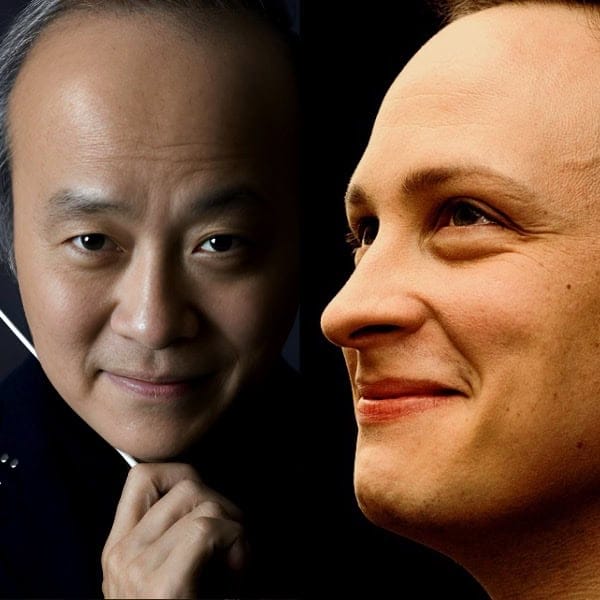 Asian man with headphones and thoughtful expression, close-up portrait.