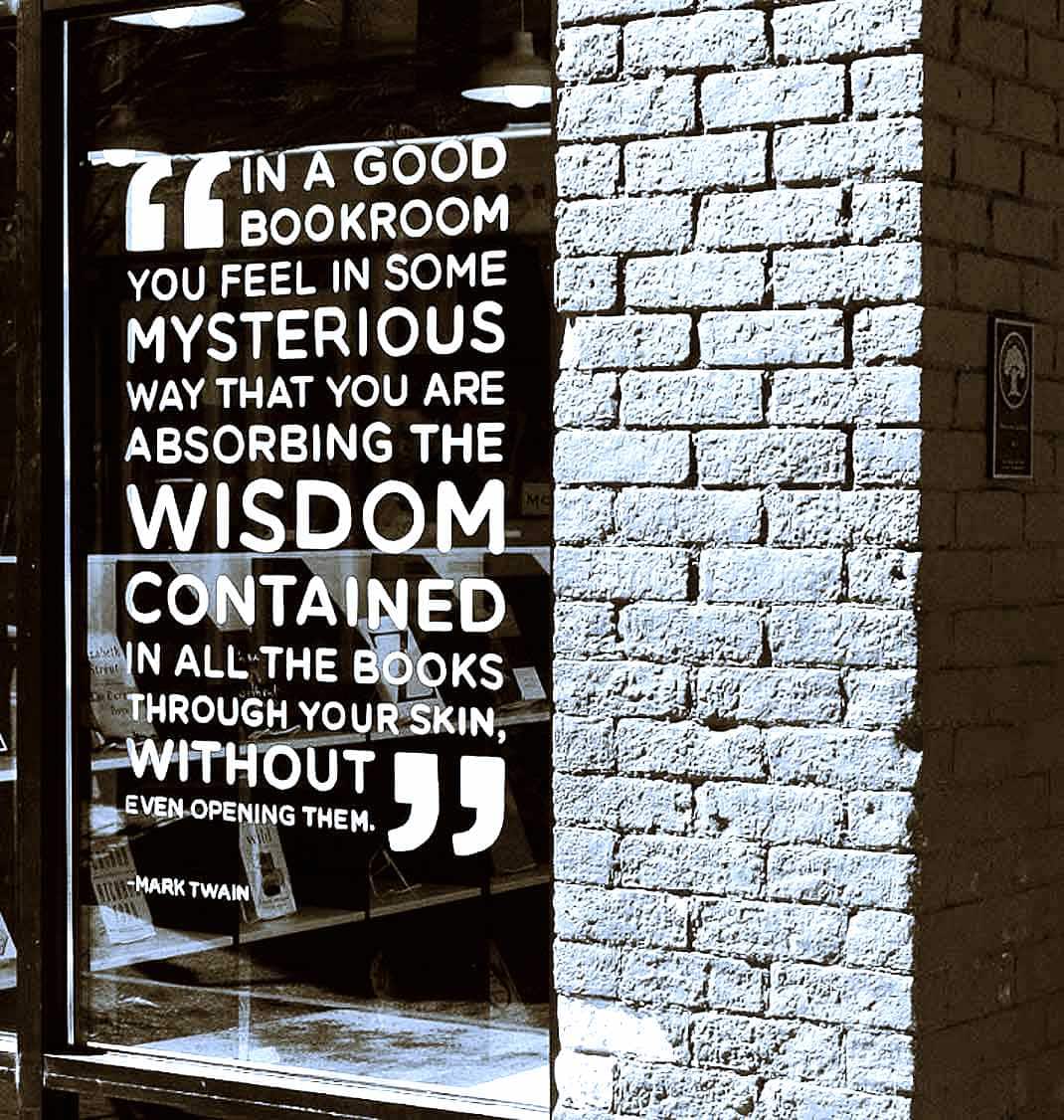 Inspiring quote about books and wisdom on a bookstore window, highlighting the importance of reading for knowledge, history, and music archives. Perfect for promoting literary and cultural heritage.