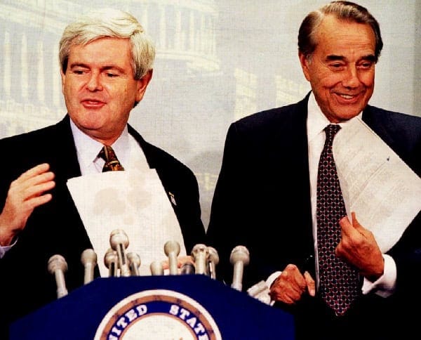 Politicians speaking at a press conference with microphones, representing political history and news coverage.