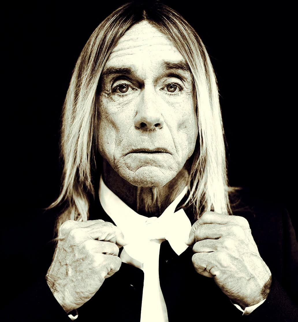 Elderly man with long hair and serious expression, black and white portrait, vintage style, music and history archive, iconic figure, classic look, retro theme, nostalgic imagery, historical photo, pastdaily news archive relevance.