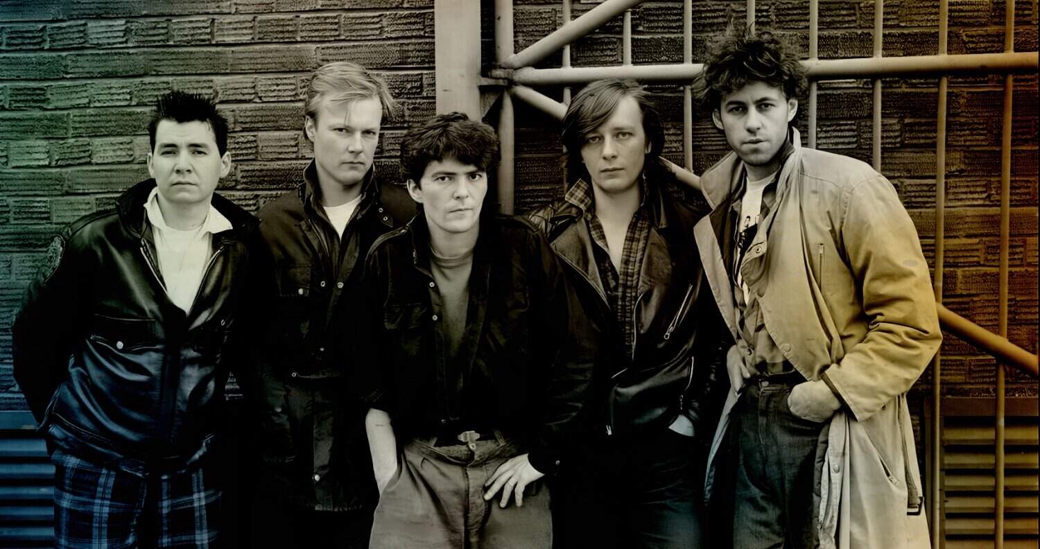 Music band playing instruments, 1980s rock band with grunge style, young musicians in leather jackets and casual clothing, urban background, alternative music scene, band members standing outdoors in city evening light.