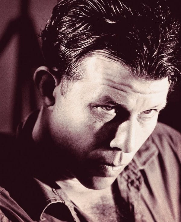 Male actor with intense expression, vintage film still, classic movie scene, black and white movie shot, mid-20th century film actor, moody cinematic portrait, film noir style.