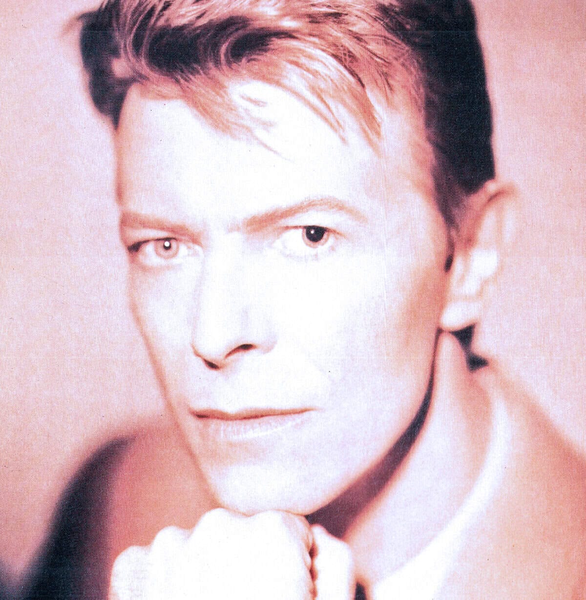 Vintage portrait of David Bowie, British musician and icon, highlighting his distinctive hairstyle and intense gaze, in a high-contrast, artistic style for music history and pop culture SEO.