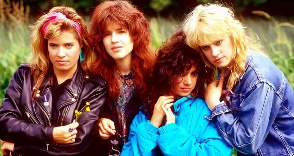 Colorful 1980s girl group dressed in vibrant styles outdoors, showcasing fashion, music, and pop culture.