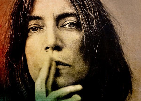 Close-up black and white photo of a woman with long hair, contemplative expression, hand touching her lips, evoking reflection, nostalgia, and timeless music, perfect for a sound archive of news, history, and music.