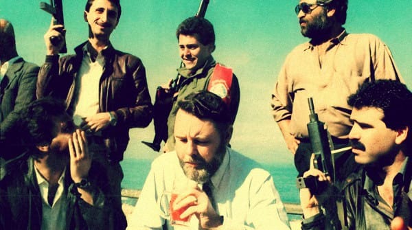 A group of people with cameras and microphones outdoors during a film or news shoot, showcasing media production, journalism, and historical documentary activities.