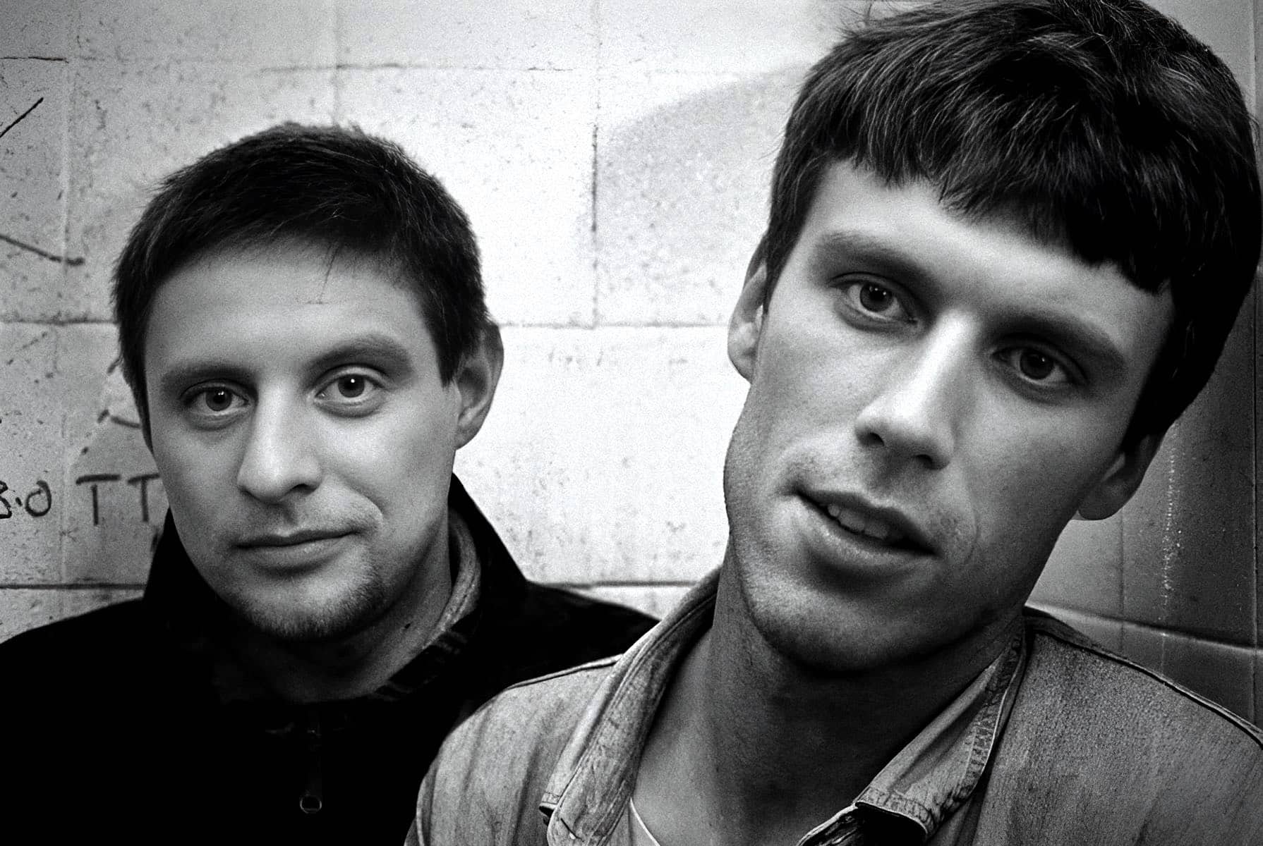 Portrait of two young men with dark hair, close-up black and white photo, emphasizing music and cultural history themes, suitable for sound archive websites.