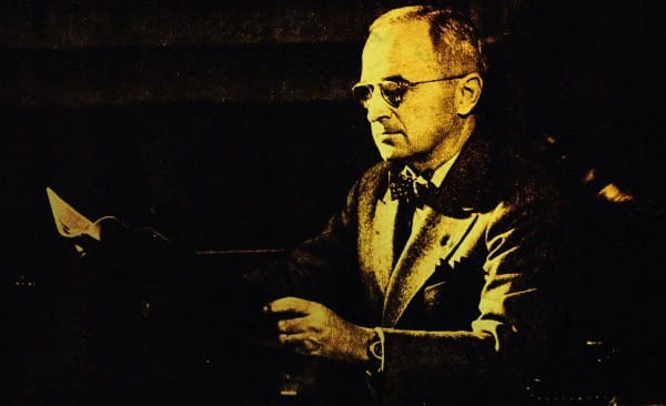 Historian reading a newspaper in a vintage setting, reflecting past news, history, and cultural archives.