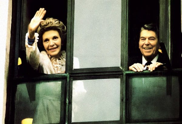 Past daily historical news music archive, historic political figures waving from train window, vintage media coverage, significance of news and entertainment archives, sound archive of history and music.