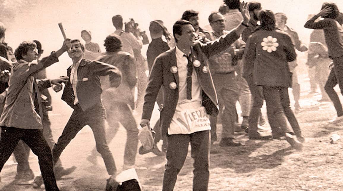 Children celebrating with joyful enthusiasm during a historical protest or rally, capturing a moment of social and political significance with vintage black-and-white photography.