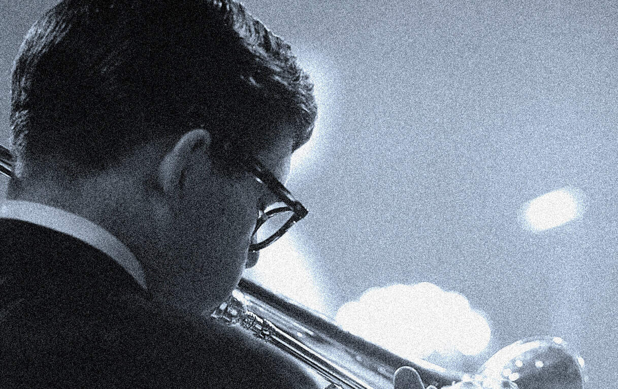 Silent jazz musician playing trumpet, black and white photo, classic music and sound archive imagery, historical jazz scene.