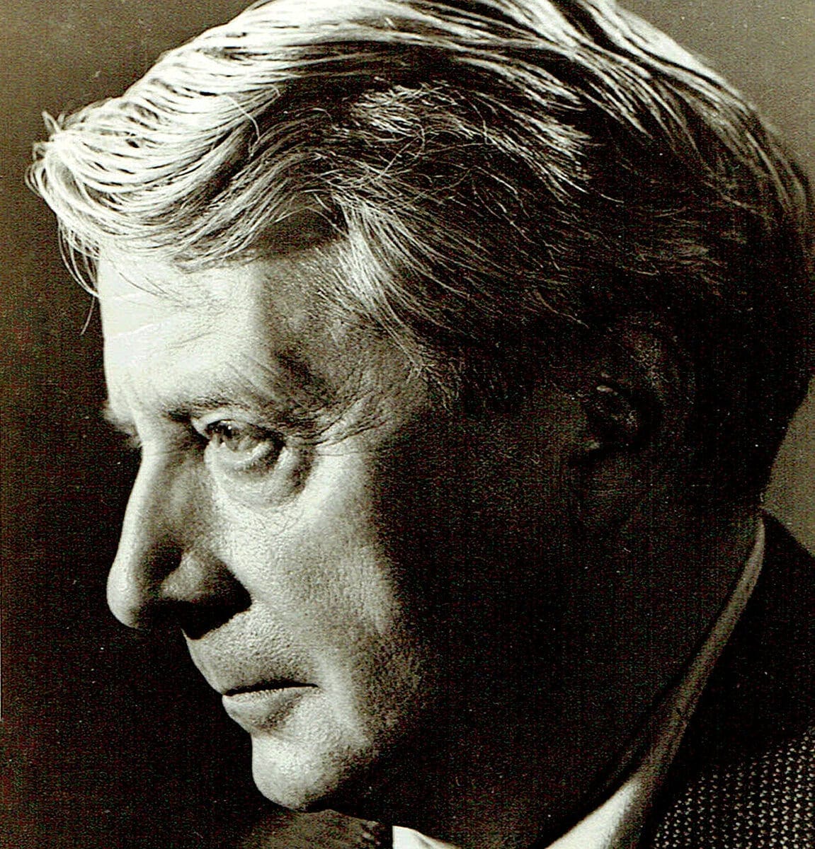 Vintage black and white image of a distinguished man with classic hairstyle, highlighting historical news, music, and radio archives from Past Daily.