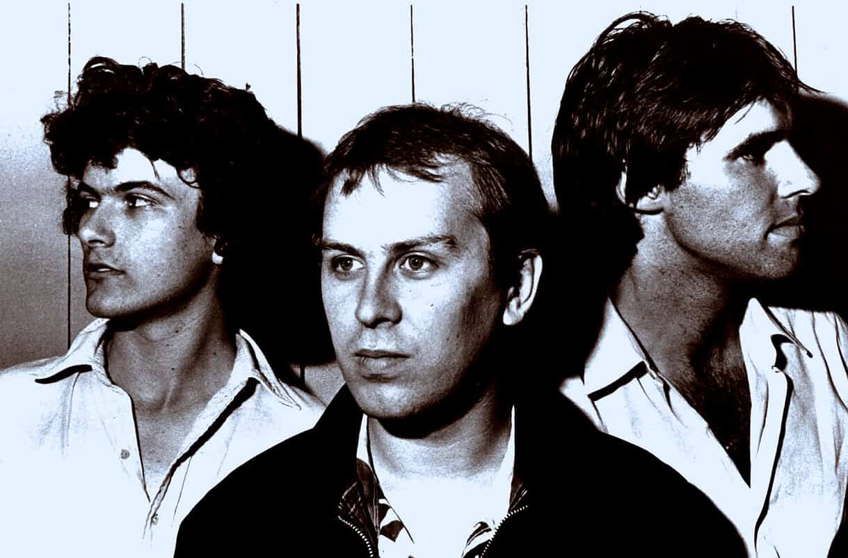 Archival black-and-white photo of a 1980s rock band with three members showcasing classic band portraits, perfect for music history, nostalgia, and vintage music archive content.