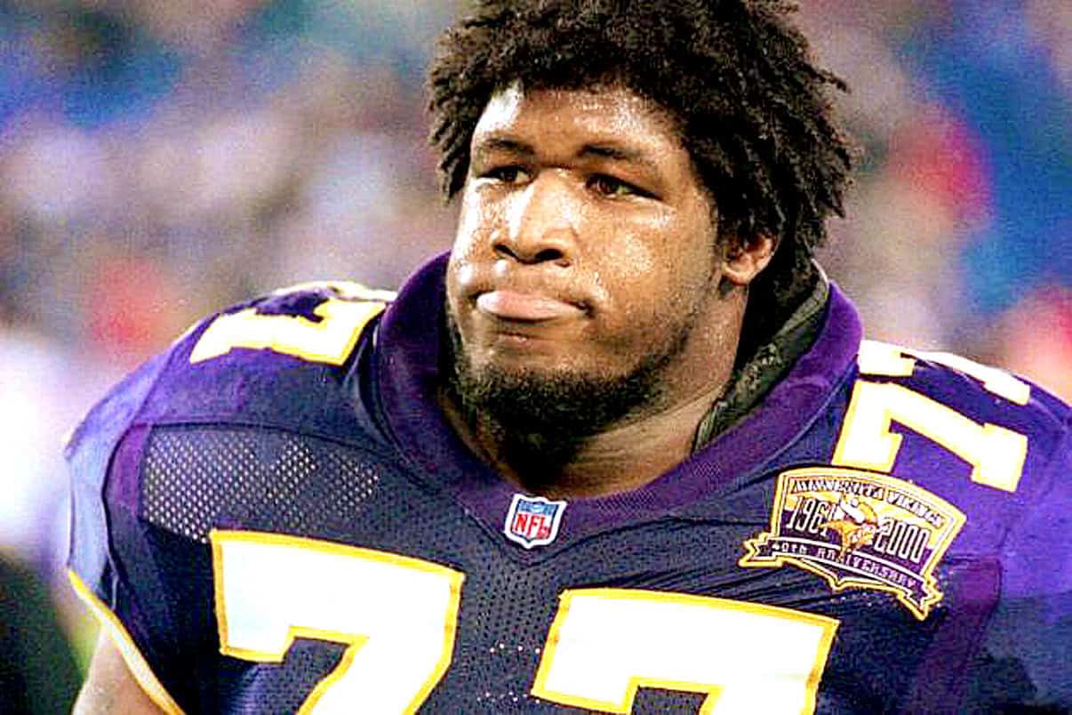 Legendary football player wearing Minnesota Vikings jersey celebrating on the field - NFL sports history, American football, past games and memorable sports moments.