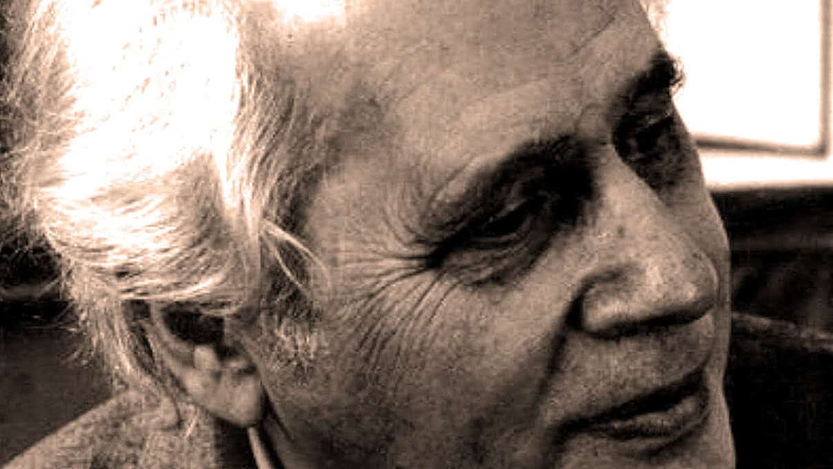 Close-up of elderly woman with gray hair, capturing expressive facial features and wrinkles, emphasizing history and life experiences in a documentary or music archive context, part of a sound archive of news and history images.