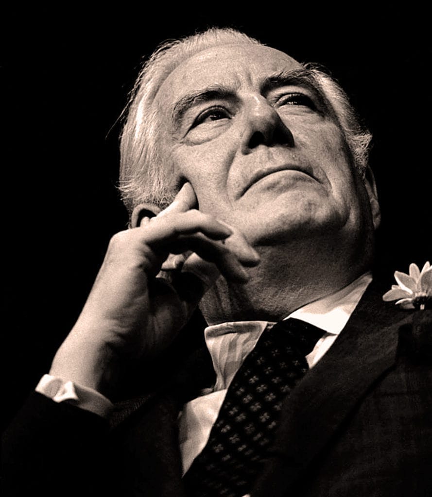 Portrait of a distinguished elderly man in formal attire, thoughtful expression, black and white image, representing historic news, music, or cultural archives for Past Daily.