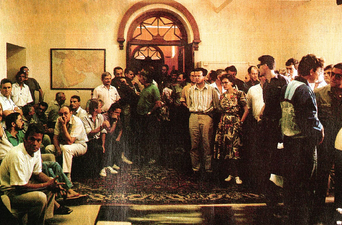 People waiting in line at a news archive or historical collection exhibit, capturing the essence of vintage news, history, and music archival preservation.