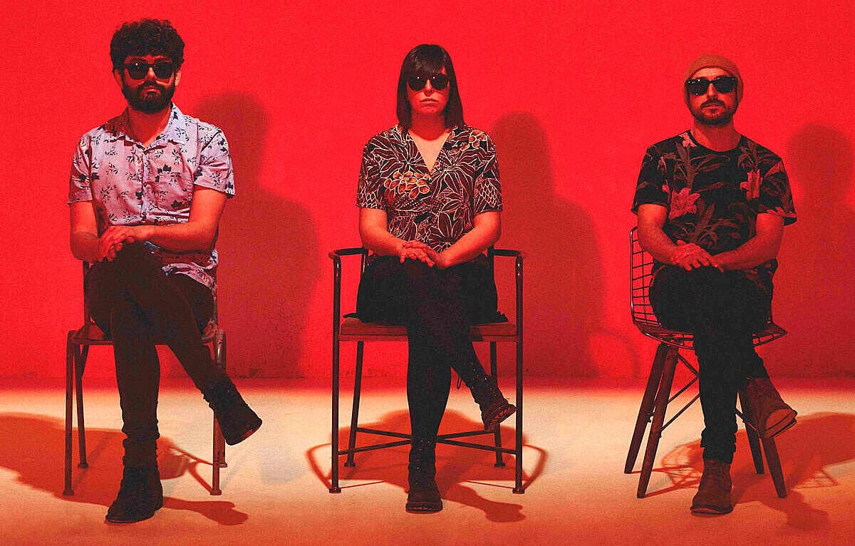 Vintage band portrait with members wearing sunglasses and patterned shirts, emphasizing 1960s music and rock history, perfect for archives focusing on music, pop culture, and historical sound recordings.