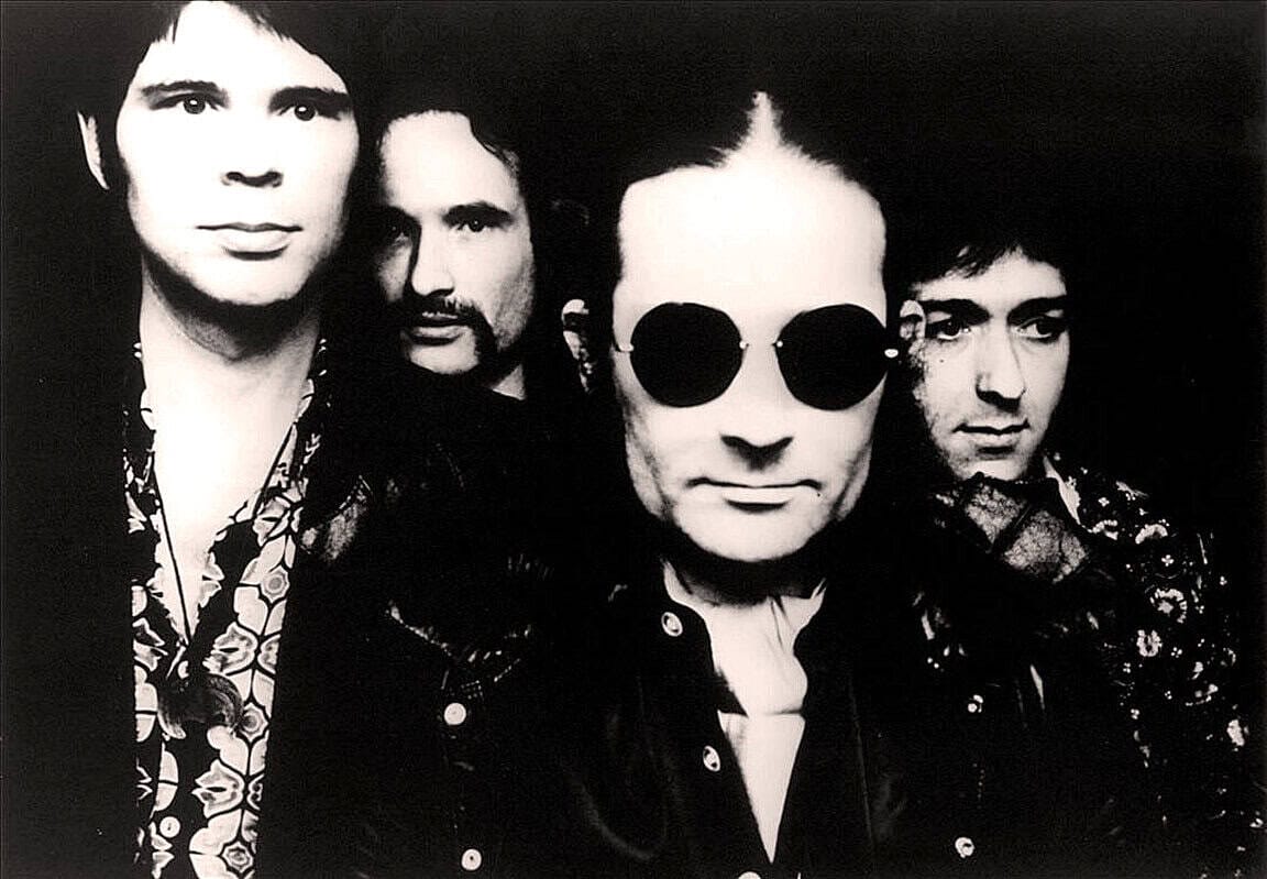 Black and white photo of the band members, emphasizing 1980s rock music, with a focus on history and music archives from Past Daily.