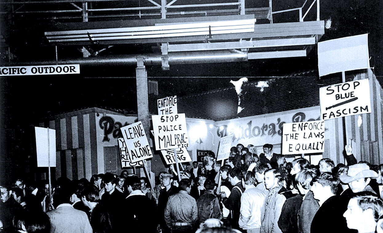 Protest signs and crowd at anti-fascism demonstration showcasing history of activism at Past Daily archive.