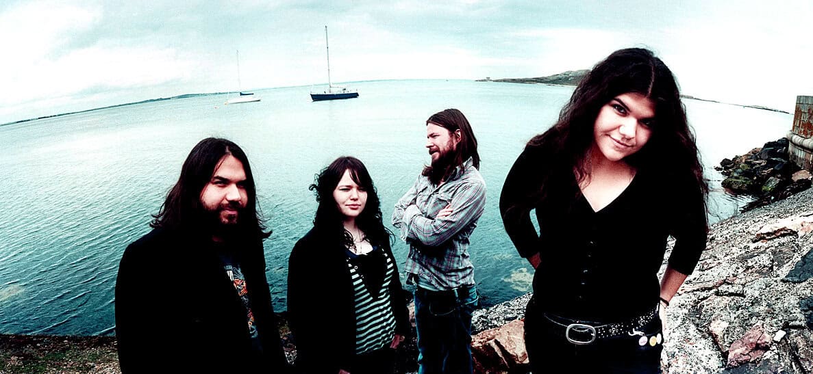 Creative group of musicians on a coastal shoreline enjoying music and history; perfect for a sound archive of news, history, and music compilations.