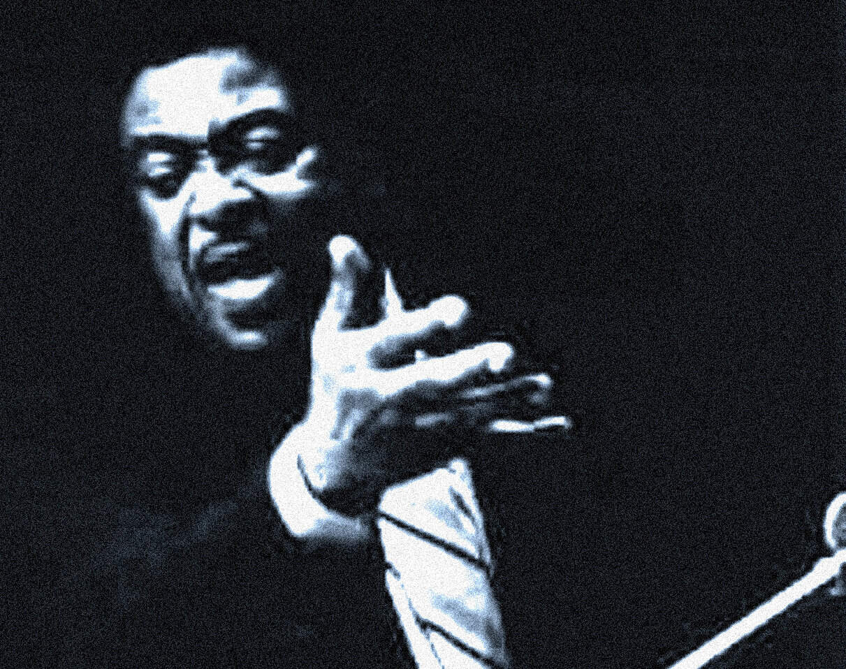 Vintage black and white image of Miles Davis, legendary jazz trumpeter, captured during a live performance emphasizing music history and iconic jazz musicians.