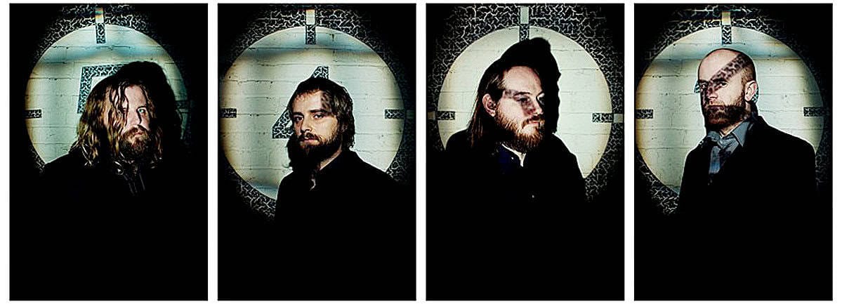 Vintage band portrait with members standing against a circular window, emphasizing music history and nostalgia. Perfect for music archives, classic rock, and historical sound recordings.