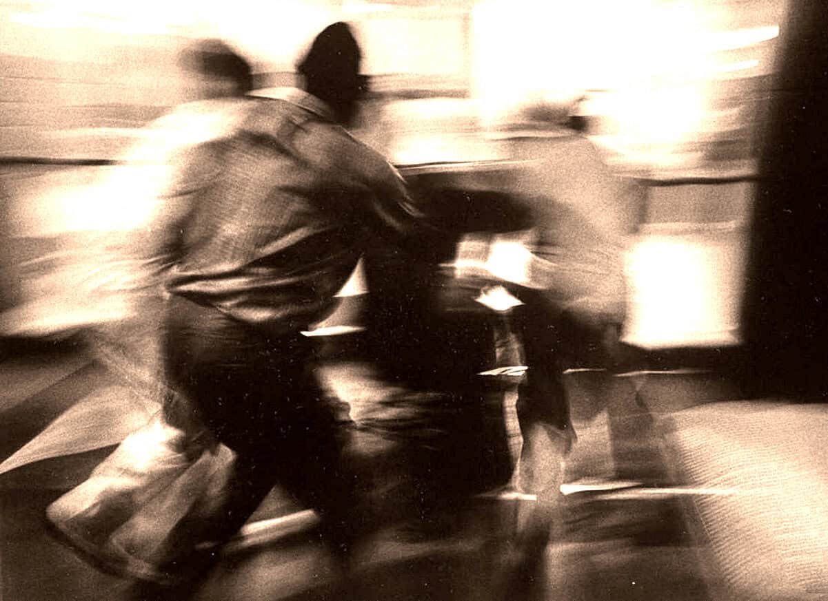 Blurry photo of a man in motion, captured in black and white, representing news, history, and music archives.