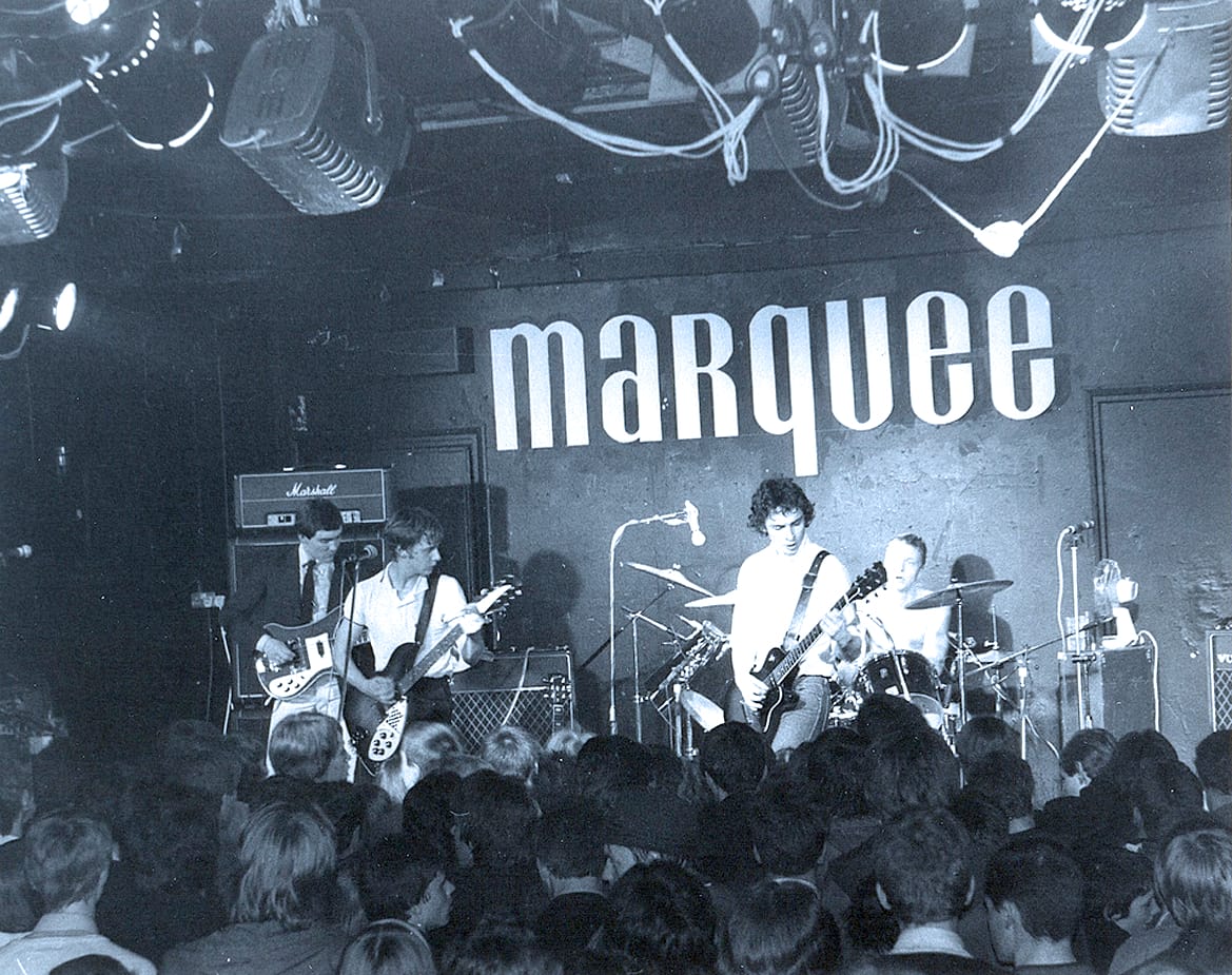 Live music performance at Marquee nightclub with a band on stage and an enthusiastic audience, highlighting music history, concert events, and iconic venues.