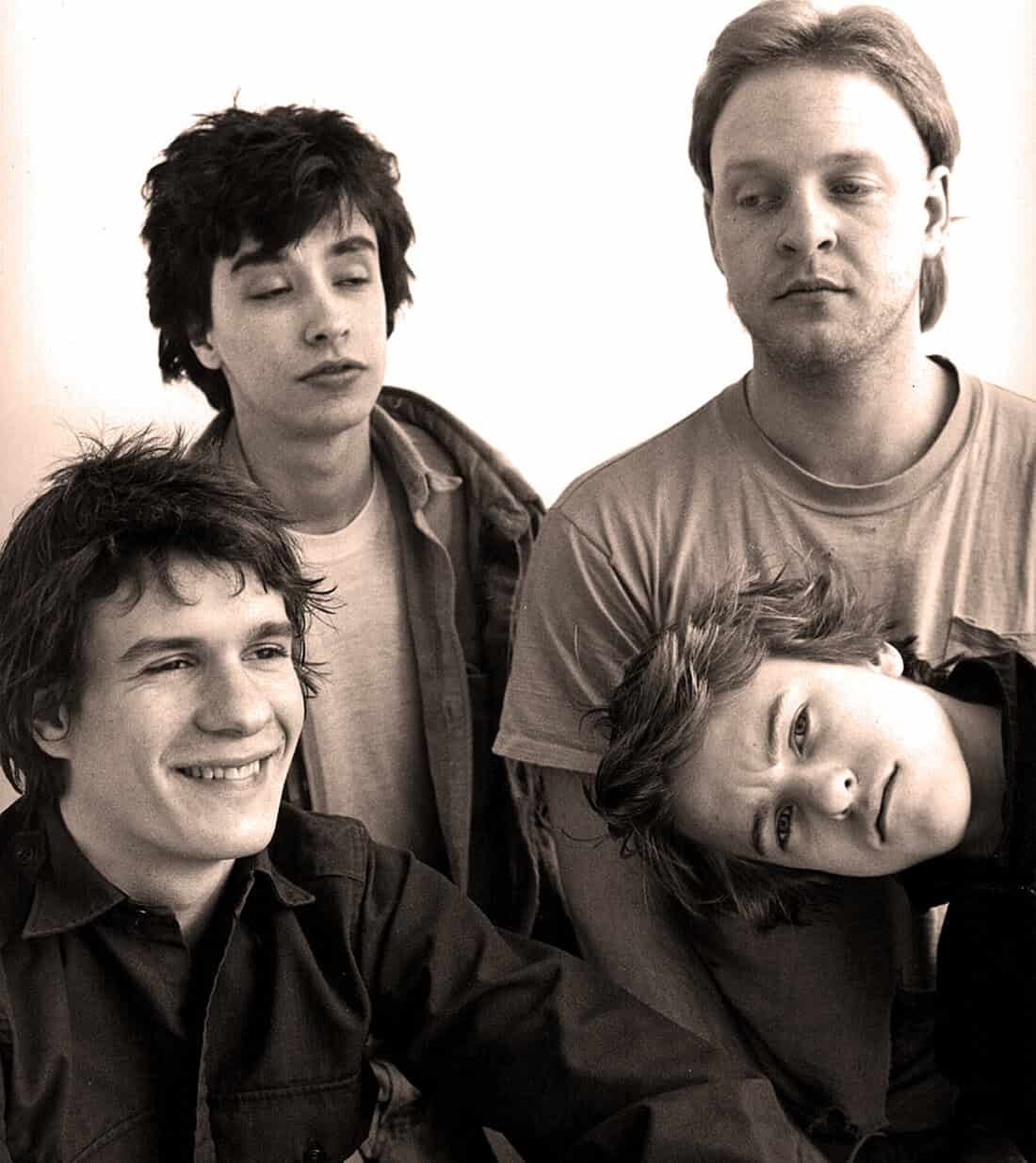 Young band members in a candid black-and-white photo representing music history and nostalgia.