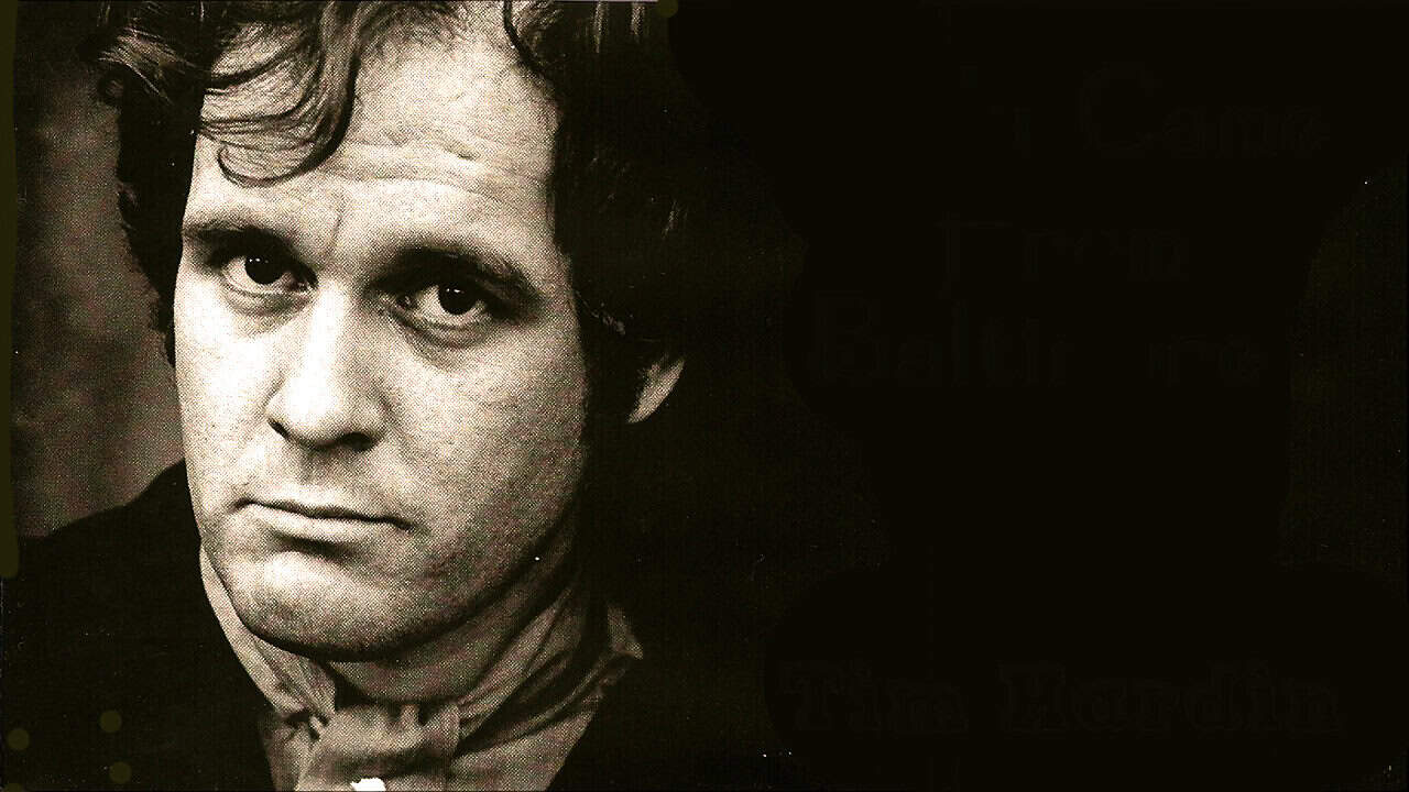 Black and white portrait of a young man with expressive eyes, vintage appearance, artful photo capturing history and music themes, evoking nostalgia and cultural significance.