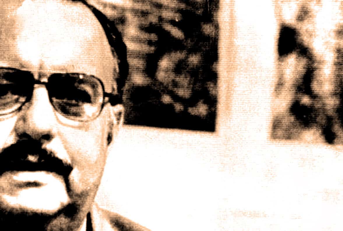 Close-up of a man with glasses, part of a historical photo related to news archives, history, and music.