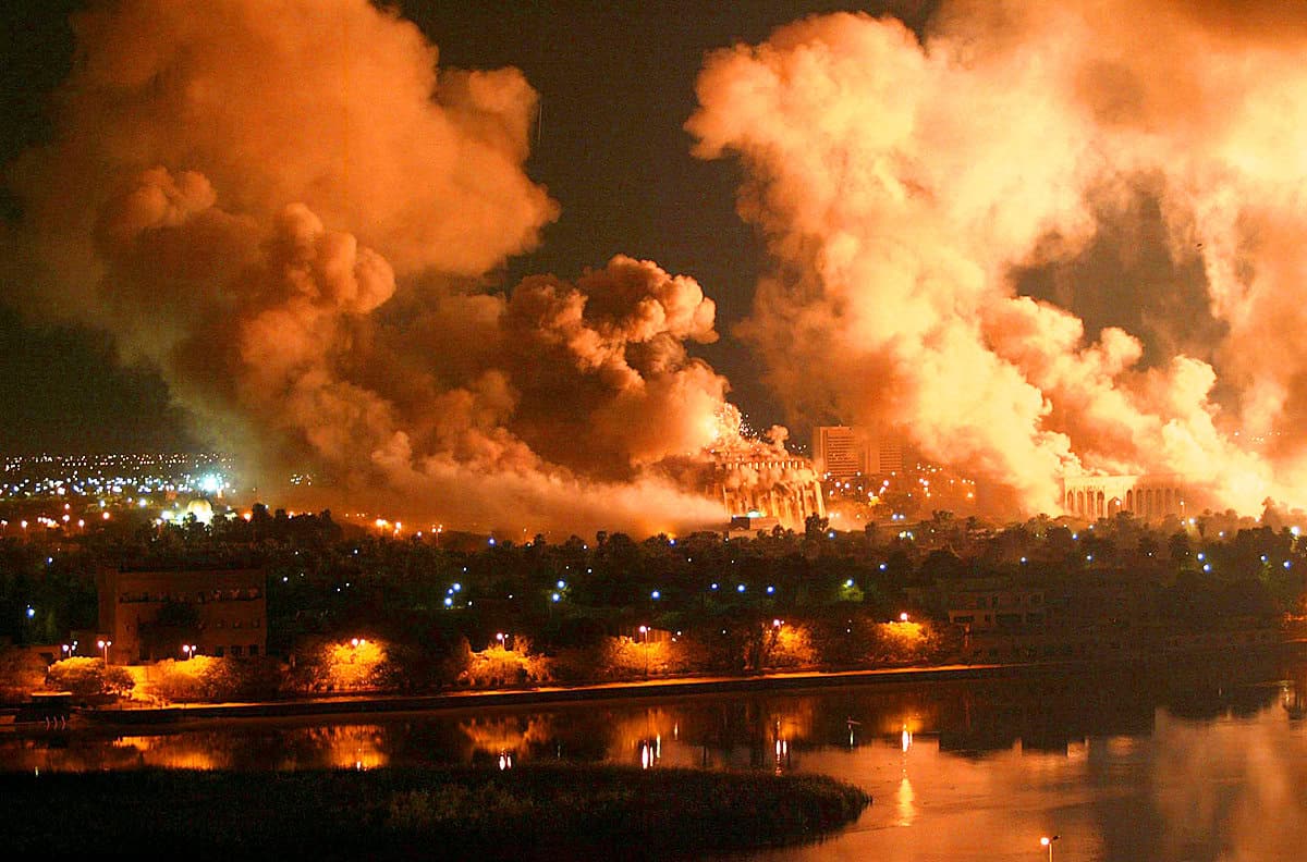 A fiery explosion with large smoke clouds over an urban area at night, illustrating a major disaster or event in history, suitable for historical news archives and sound recordings.