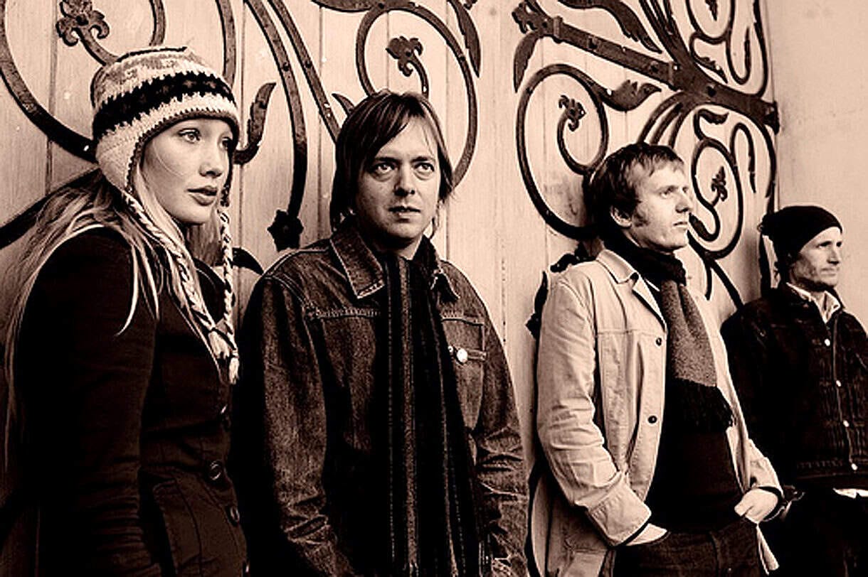 Vintage image of a band or music group listening to records, showcasing the connection between music history and archival sound collections at Past Daily.