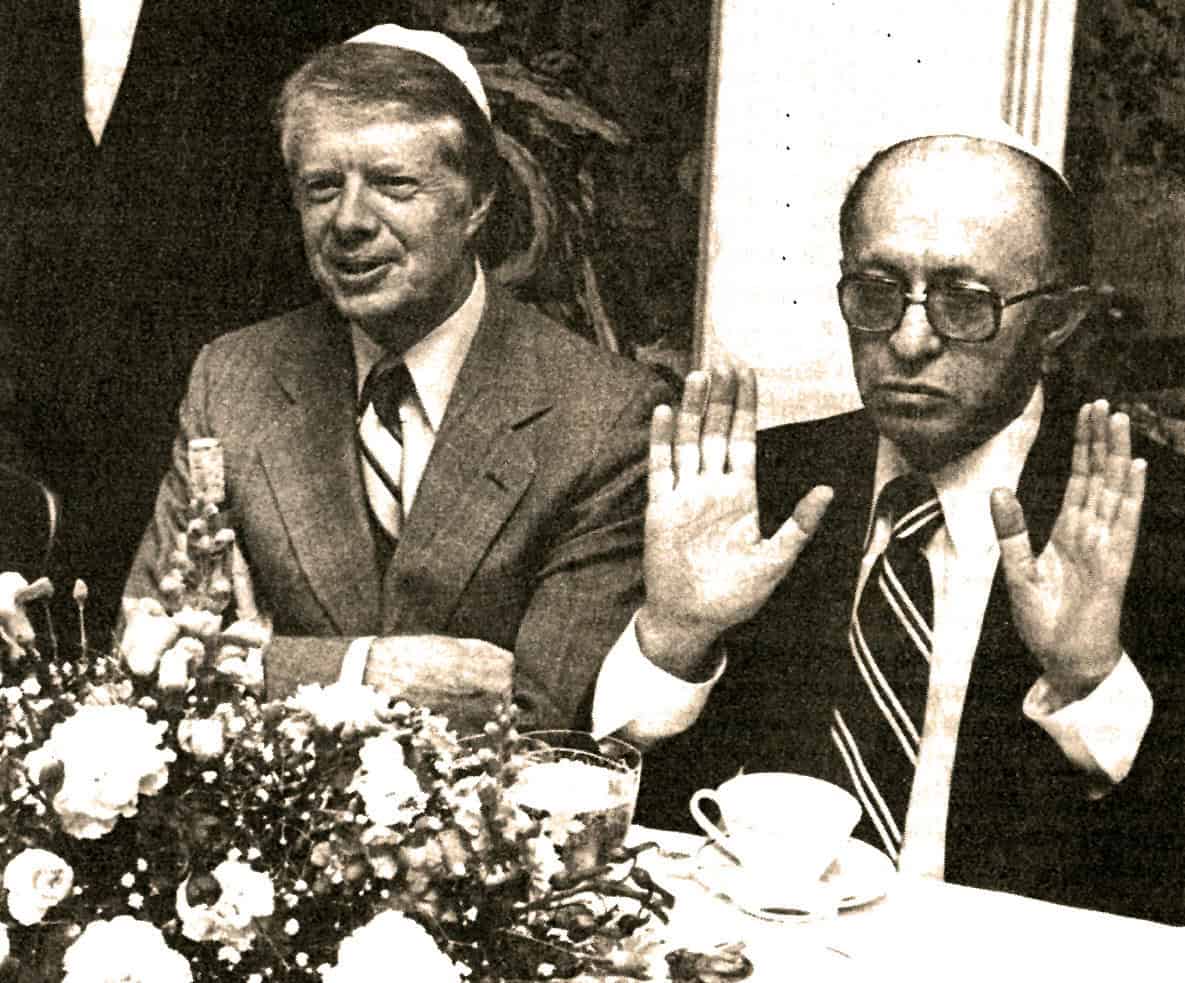 A somber man in a suit raising his hand during a meeting, with a serious expression; historical political event, vintage black and white photo.