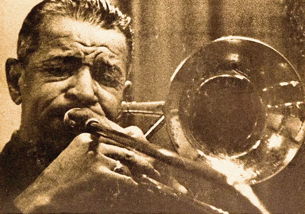 Vintage black and white photograph of a jazz musician playing the trumpet, capturing the essence of classic music, historical sound archives, and timeless news coverage.
