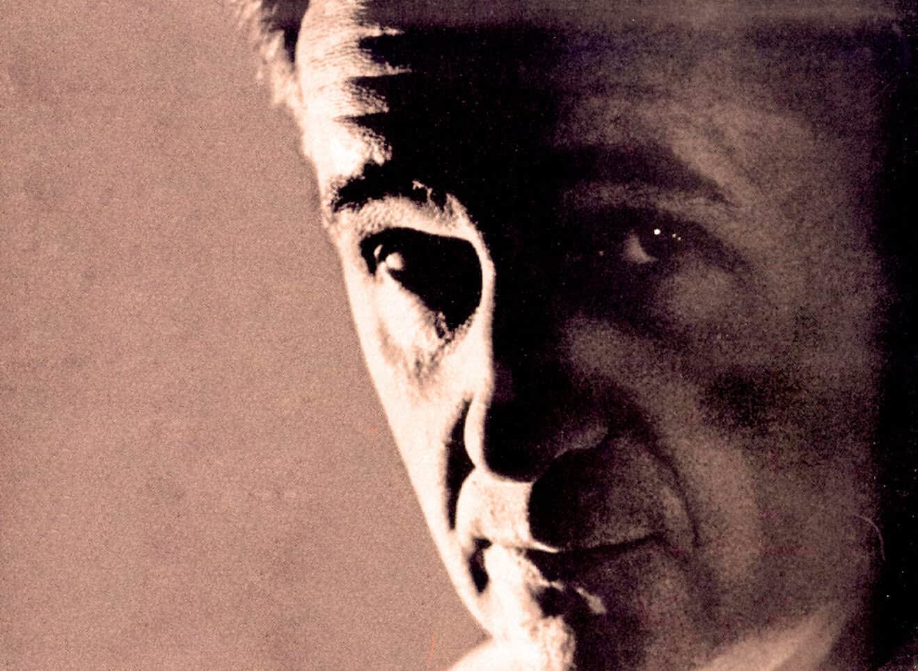 A black and white close-up image of a person with a mask inspired by Michael Jackson, emphasizing iconic pop culture and music history elements.