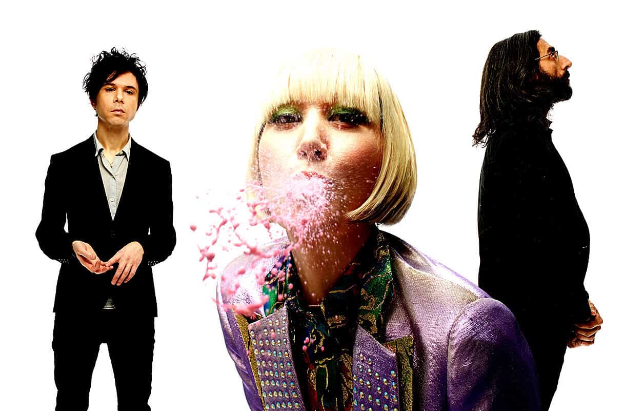 Vivid band promotional photo featuring three members with artistic editing, representing music history and cultural significance, suitable for a sound archive of news, history, and music.