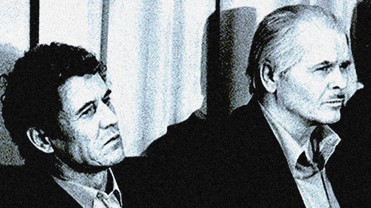 Old black and white photo of two serious men in suits, possibly from the news, history, or music archives, highlighting vintage media, historical figures, or influential personalities associated with Past Daily.