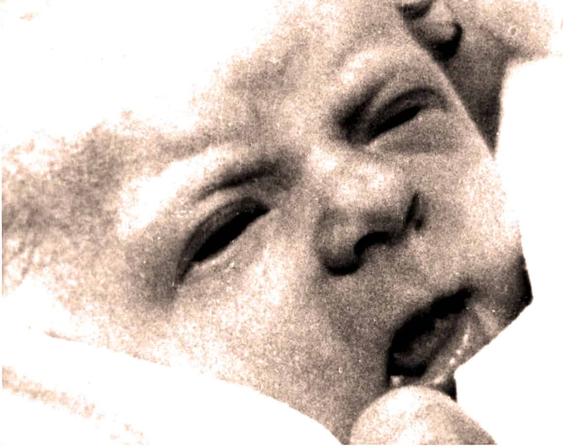 Children's laughter, joyful kid enjoying playtime, black and white vintage photo, innocence and happiness, nostalgic childhood moment.