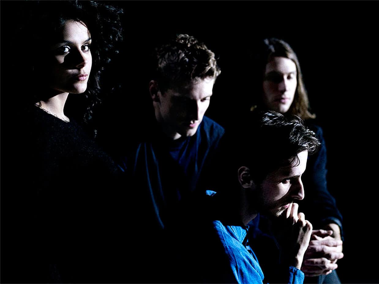 Mystery band members in dark lighting, showcasing music, history, and news themes for Past Daily sound archive.