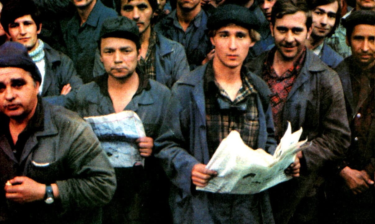 Men protesting during a historical news event, emphasizing the importance of news archives and history in media.