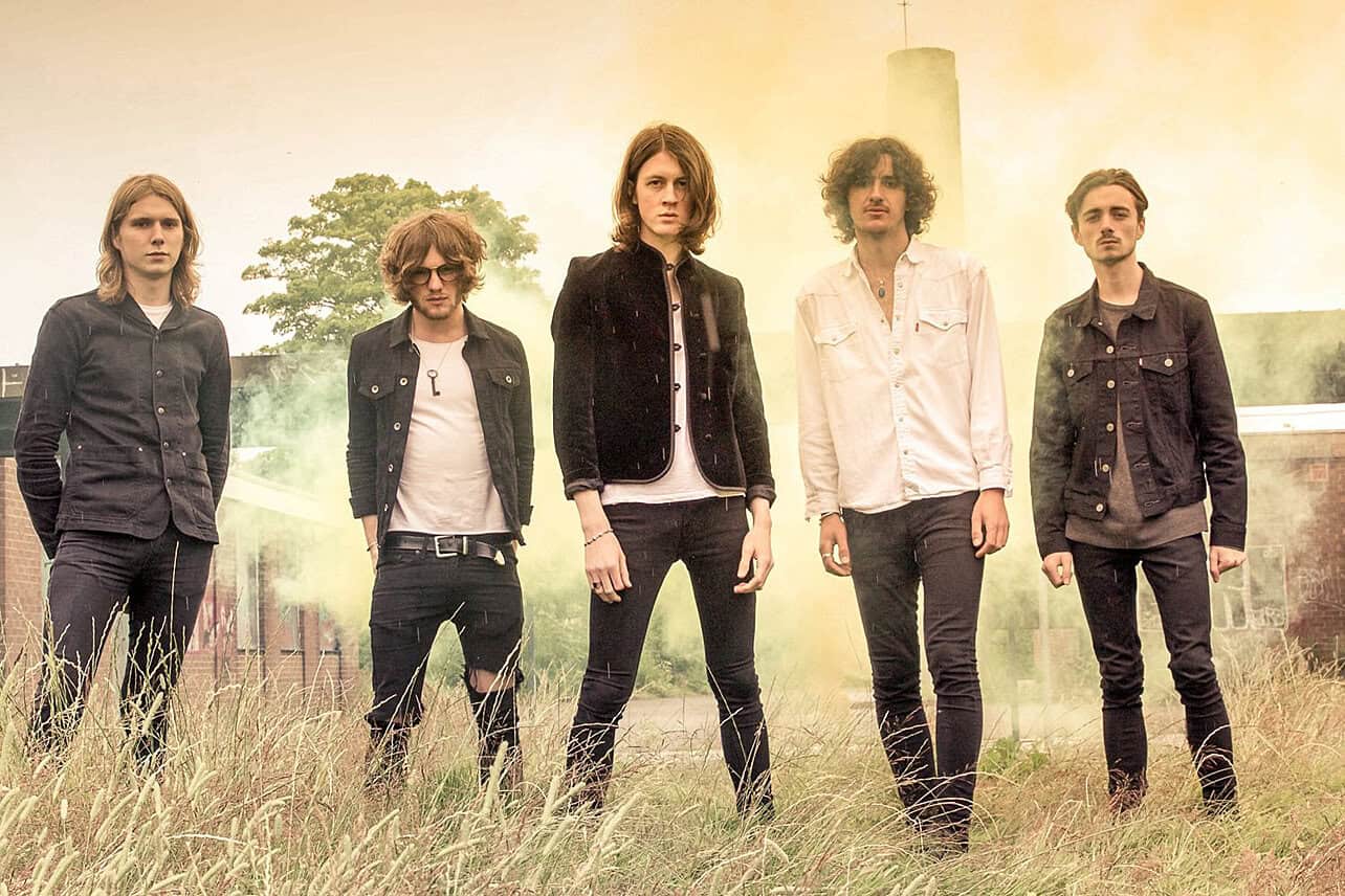 Vintage band members standing outdoors with a dreamy, nostalgic atmosphere, capturing the essence of music history and cultural moments.