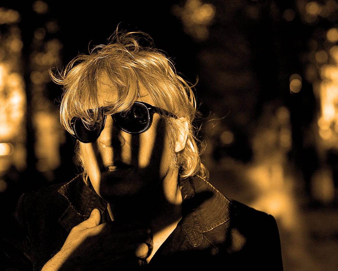 New-york-city-person-holding-earbud-in-ear-silhouette-portrait-urban-night.